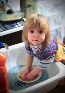 Ребенок моет посуду